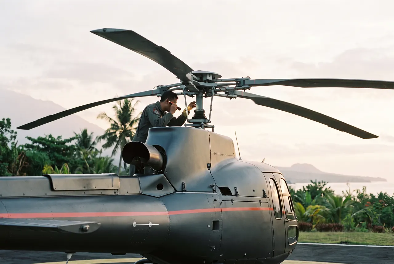 Pilot inspecting the rotor head during a pre-flight check in Bali