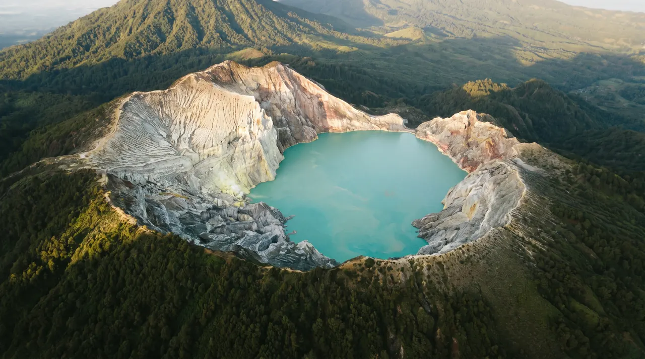 Ijen crater and turquoise lake in East Java seen from a helicopter
