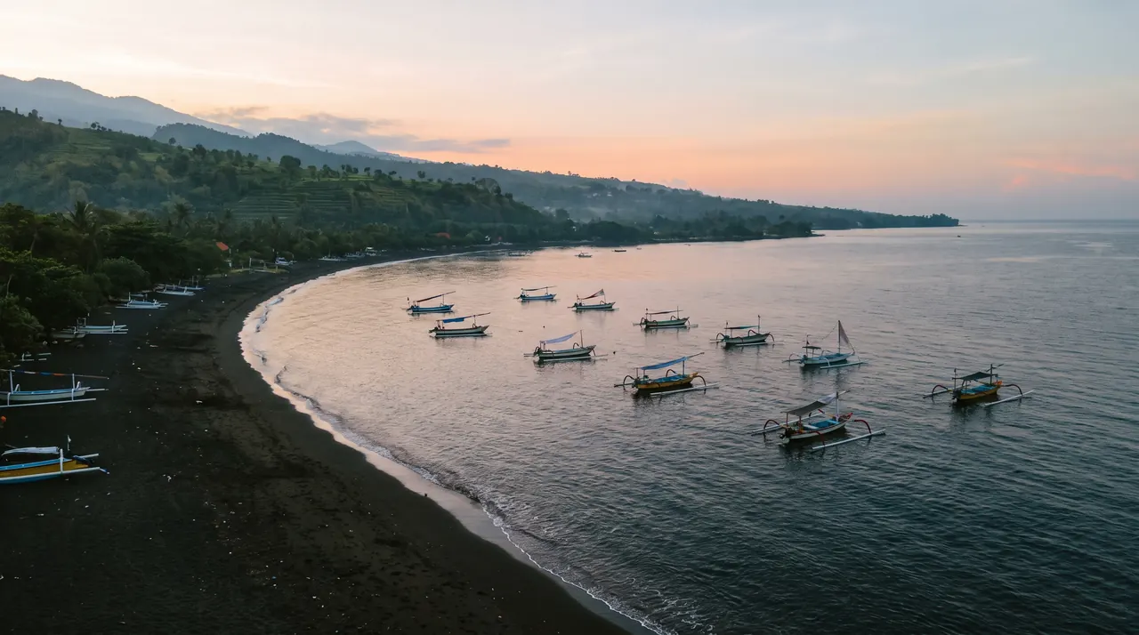 Lovina beach and fishing boats on Bali's north coast from a helicopter